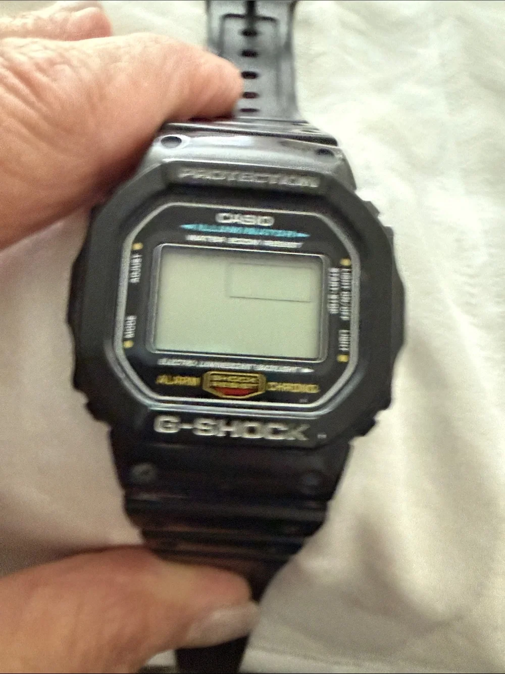 Black Casio illuminater digital watch. G-Shock resistant, waterproof.